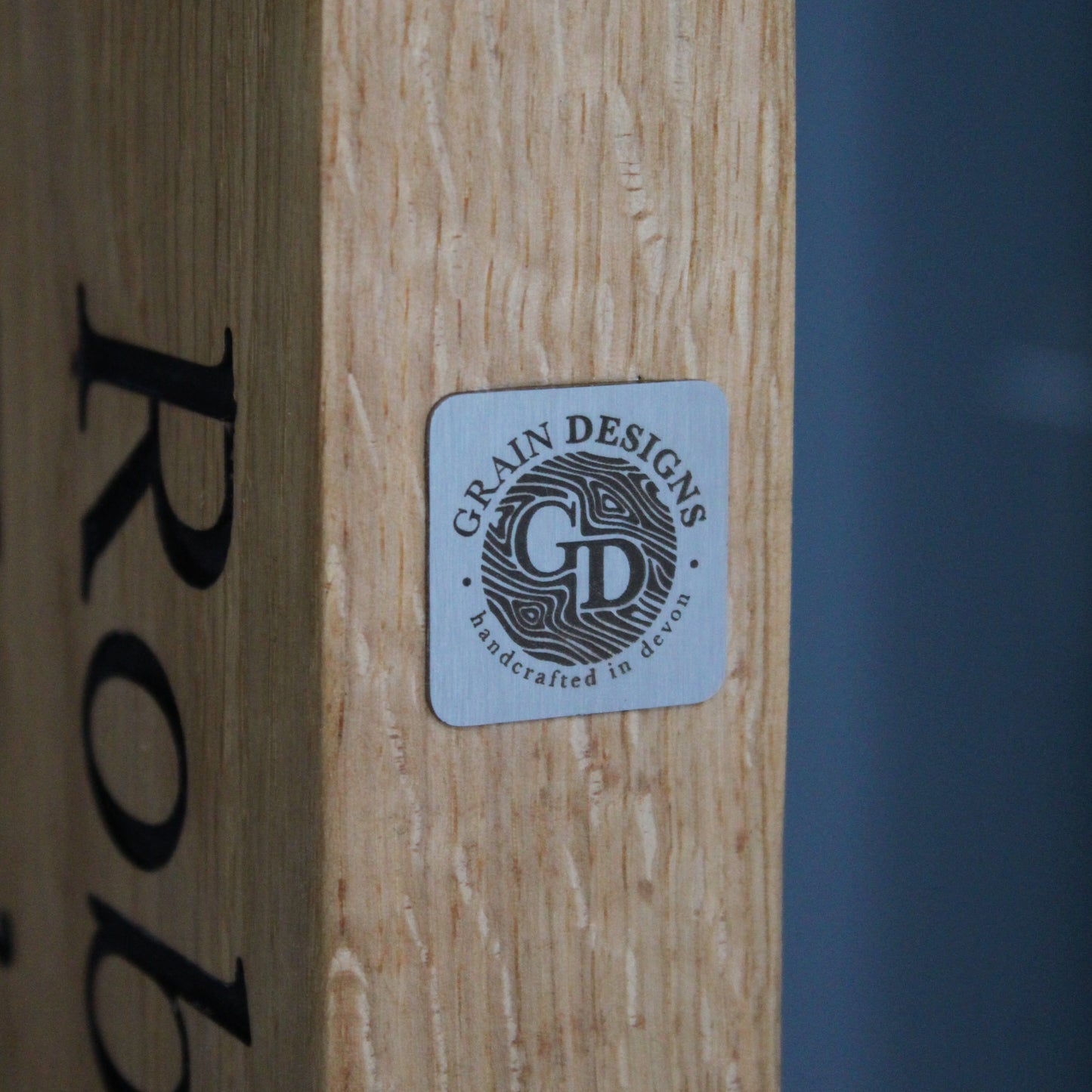 grainn design logo plate on a piece of wood
