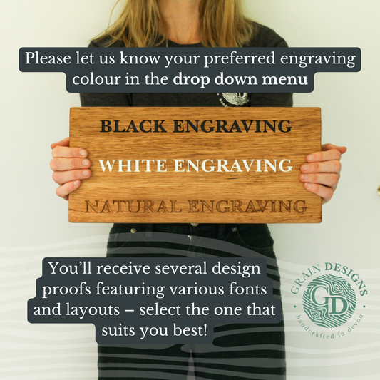 Person holding a wooden sign with engraving color options.