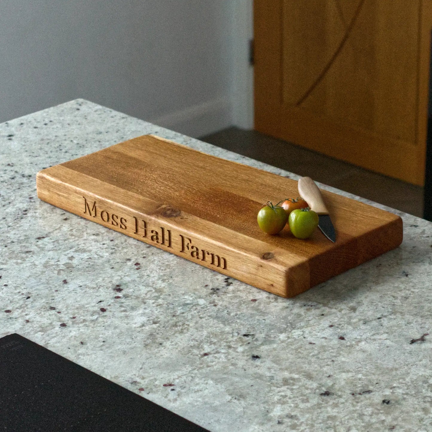 Wooden cutting board with engraved text on a kitchen counter