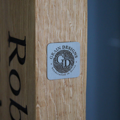 grainn design logo plate on a piece of wood