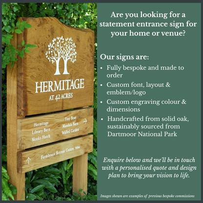 Wooden entrance sign with 'Hermitage' and tree design, surrounded by greenery.