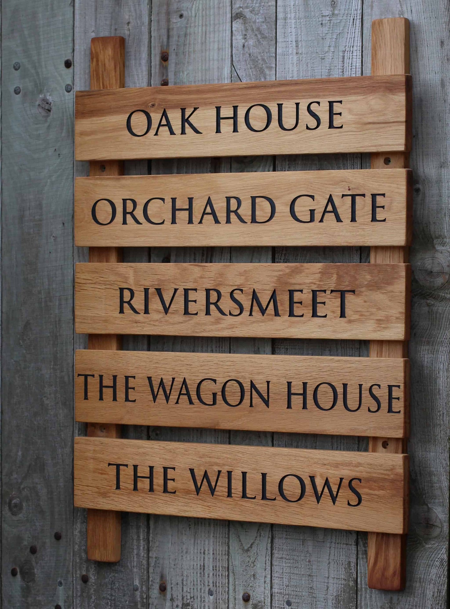 Wooden sign with engraved text on a wooden background
